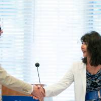 President Philomena V. Mantella shakes hands with Brooks College Interim Dean Mark Schaub